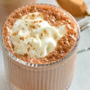 Mug of high protein hot chocolate, topped with whipped cream.