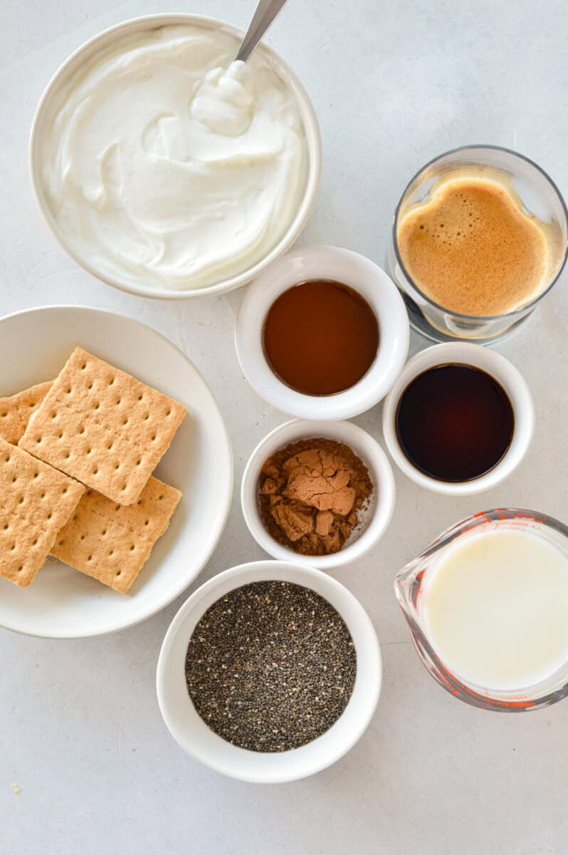 Ingredients including graham crackers, milk, chia seeds, espresso, greek yogurt, honey and vanilla.
