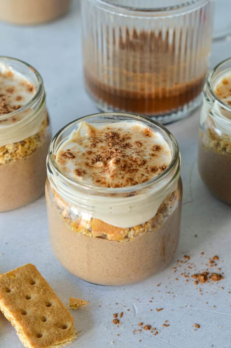 Jars of tiramisu chia pudding, topped with graham crumbs.