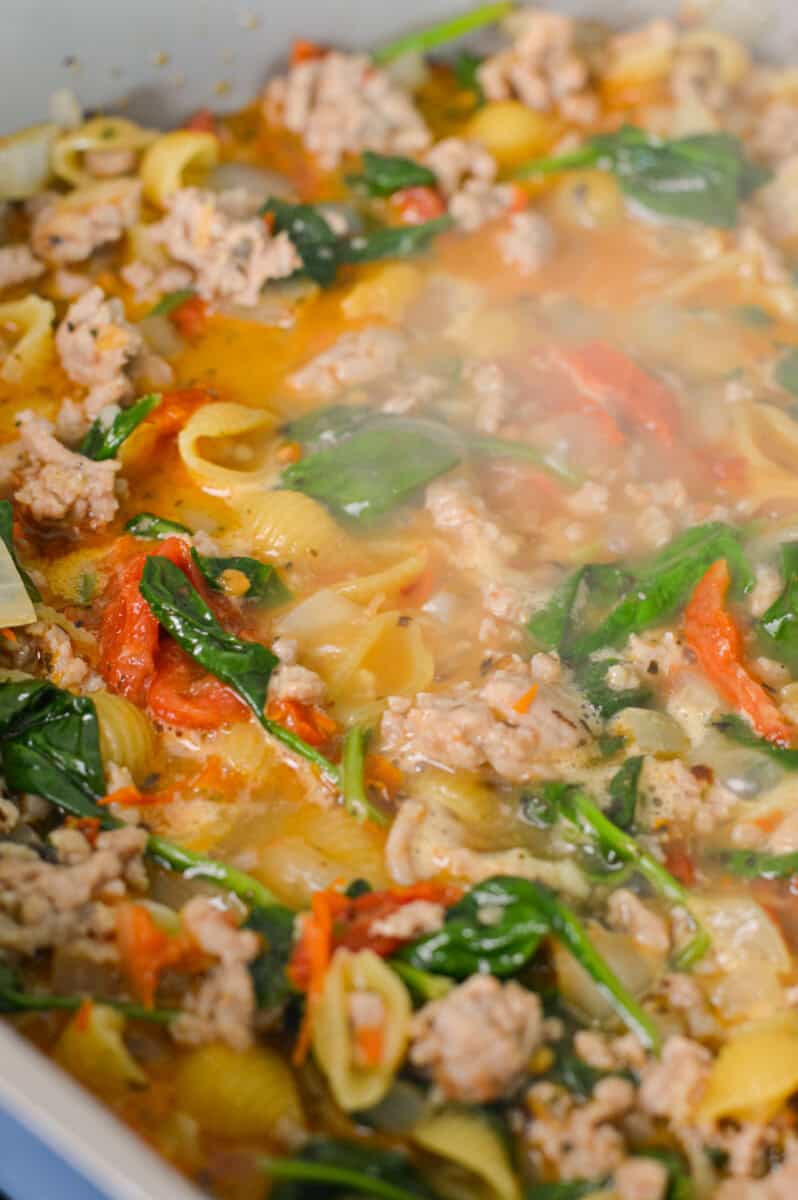 Cooking pasta in chicken broth.