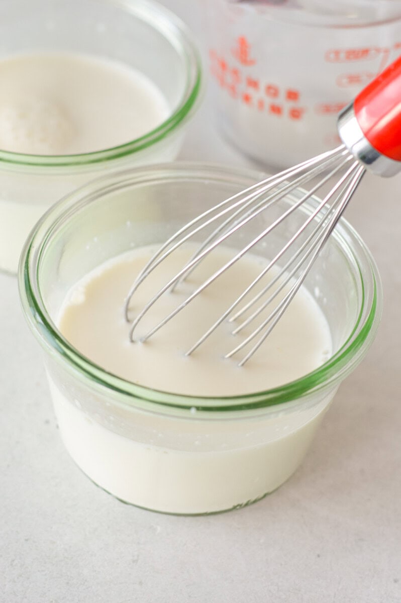 Whisking together milk and yogurt.