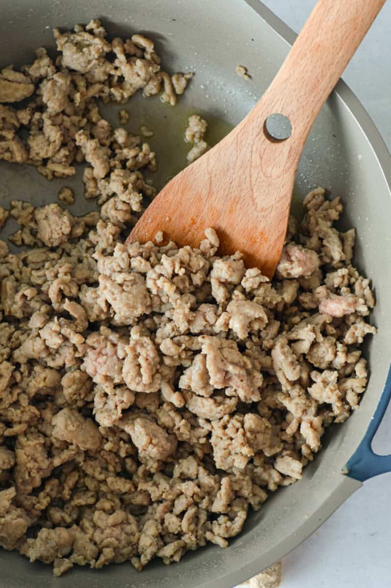 Cooking ground chicken in a pan.