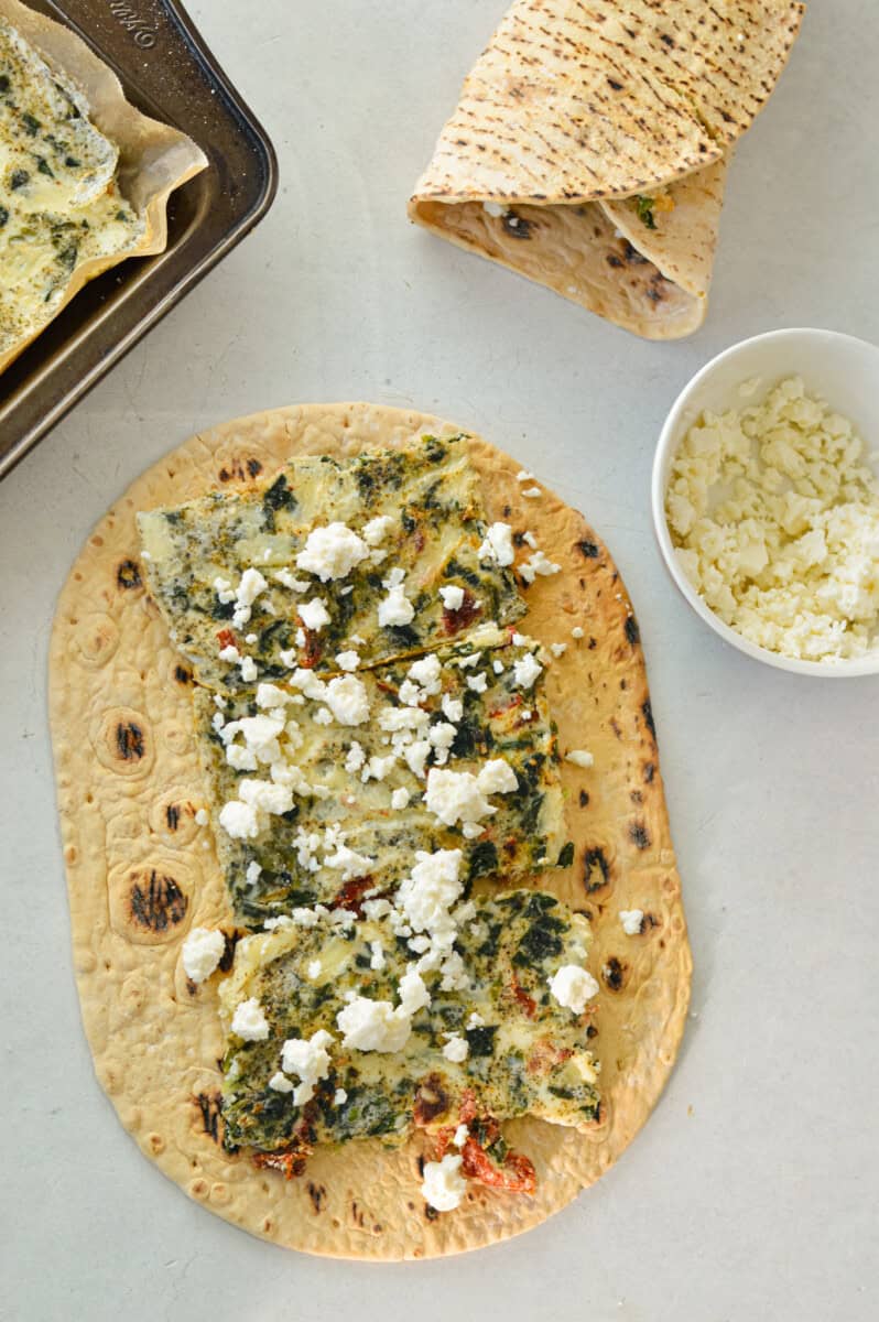Folding a spinach feta egg white wrap.