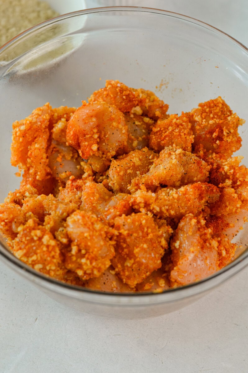Coating chicken in panko, olive oil and spices.