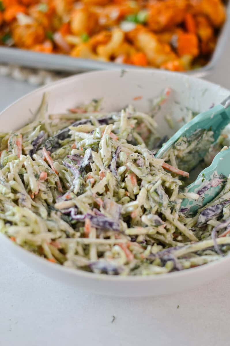 Mixing together coleslaw.