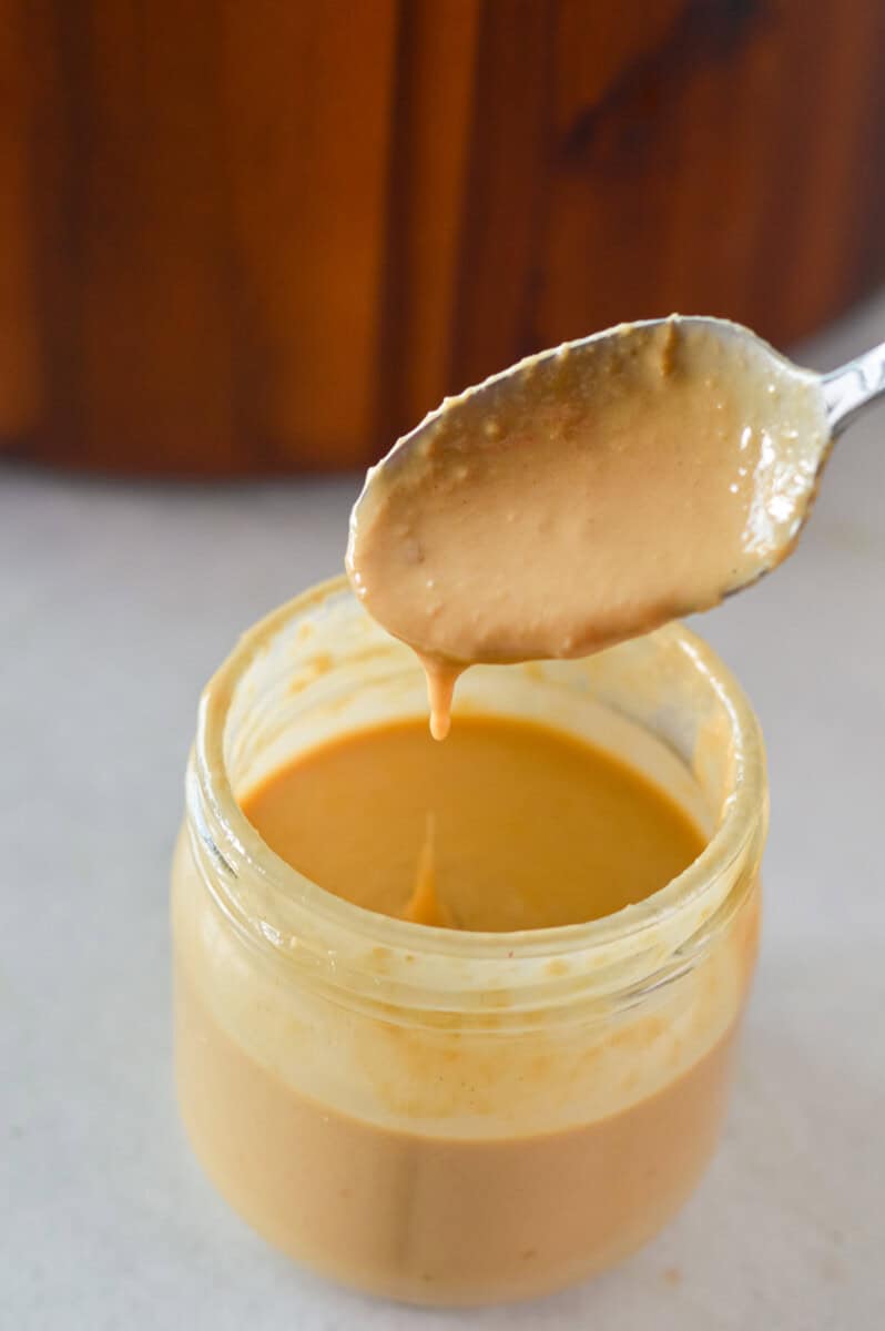 Mixing together tahini dressing.