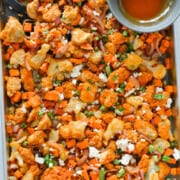 Birds eye of a sheet pan chicken and potatoes with buffalo sauce.