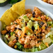 Birds eye of a bowl with southwest chicken salad, served with tortilla chips.