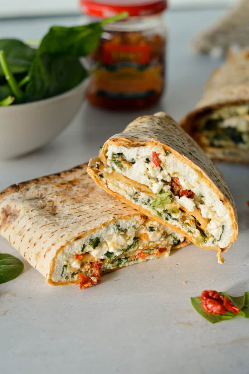 Stacking two spinach feta egg white wraps.