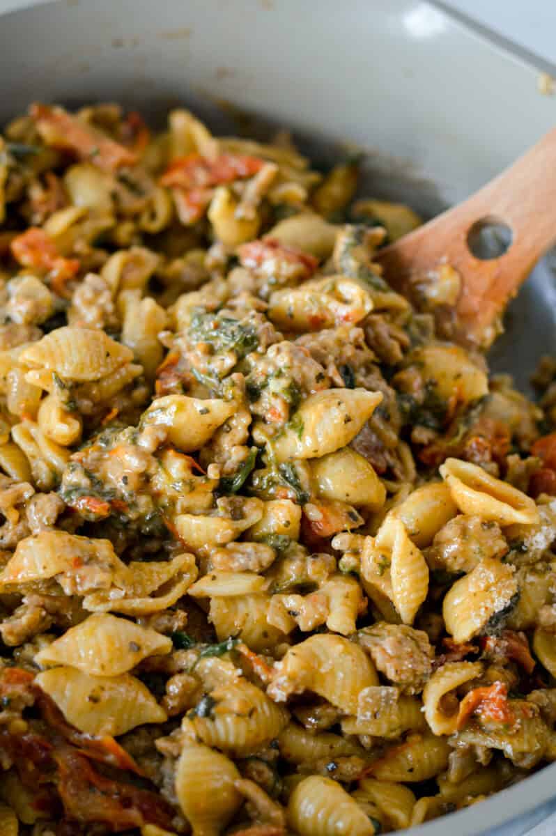 Stirring a pan of marry me chicken pasta.