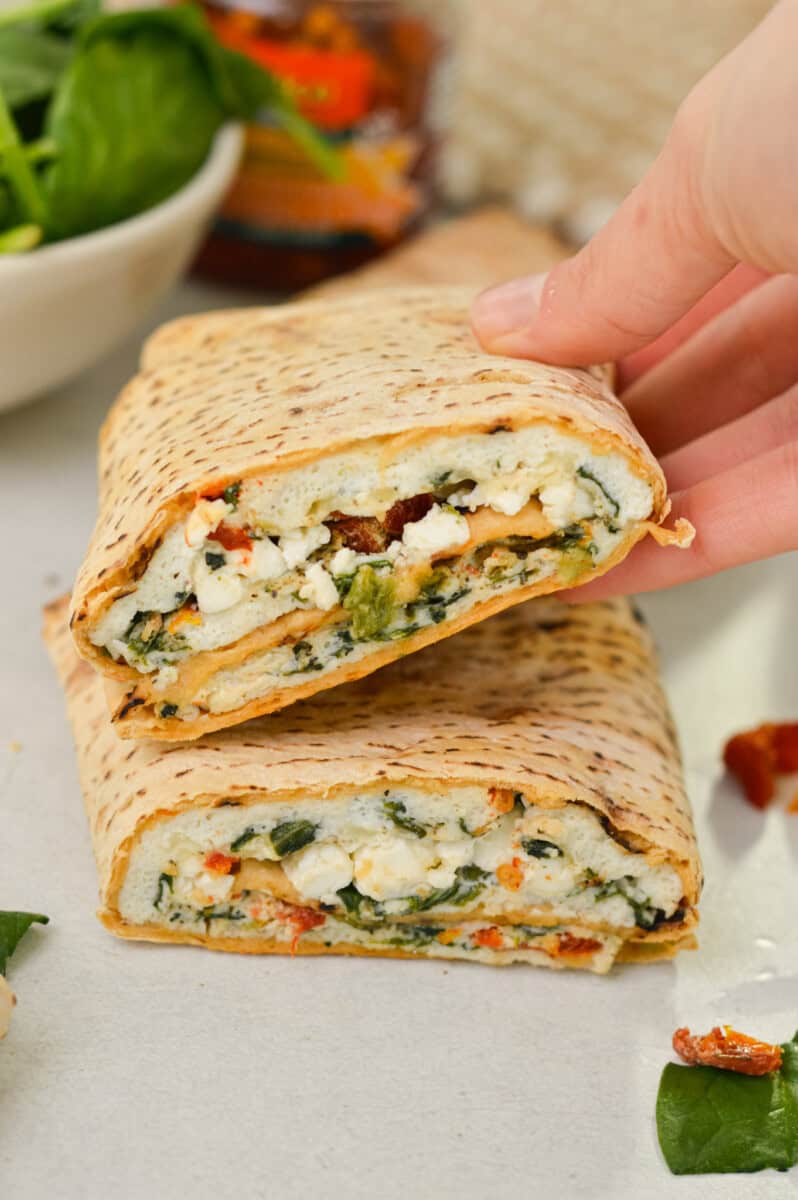 Stacking two spinach feta egg white wraps.