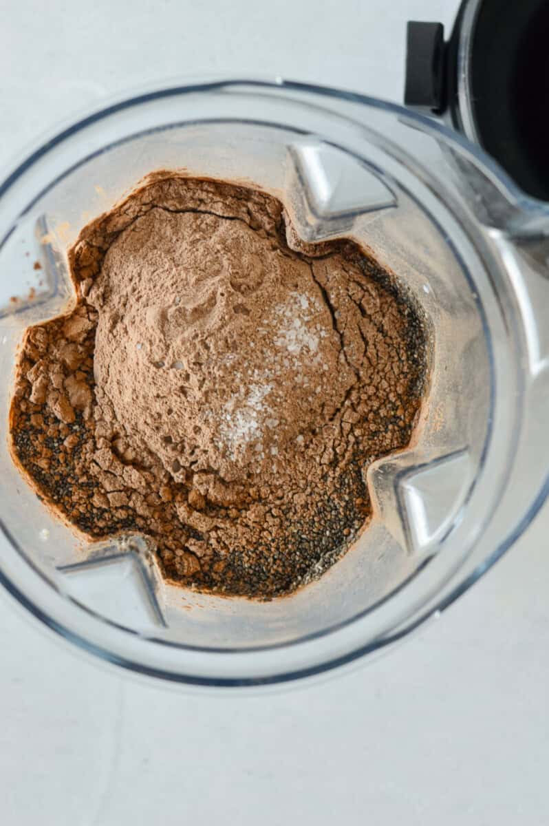 Blending chocolate chia pudding in a blender.