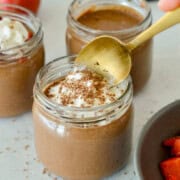 Dipping a spoon into chocolate chia pudding.