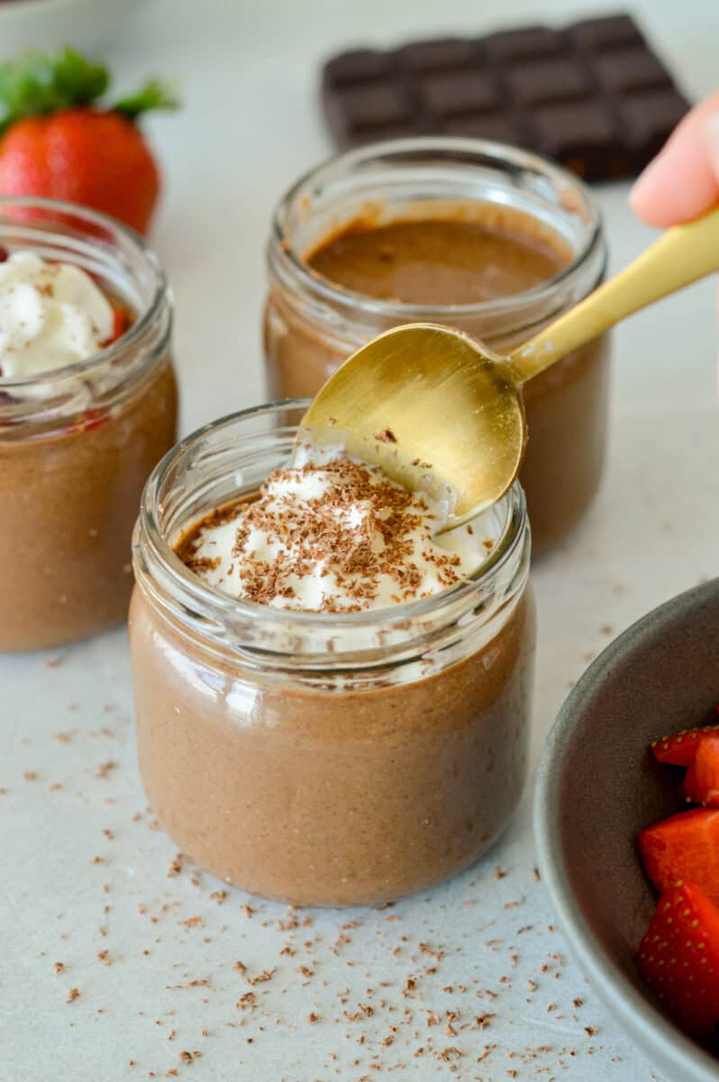 Dipping a spoon into chocolate chia pudding.