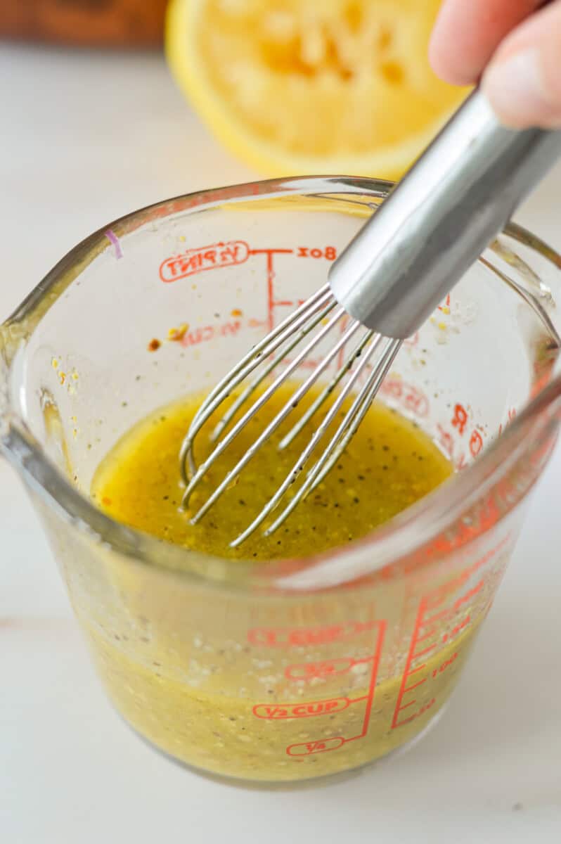 Whisking together lemon dressing.