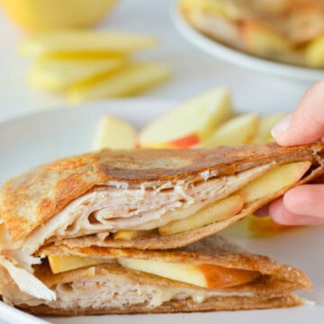 Picking up a piece of turkey apple cheddar quesadilla.