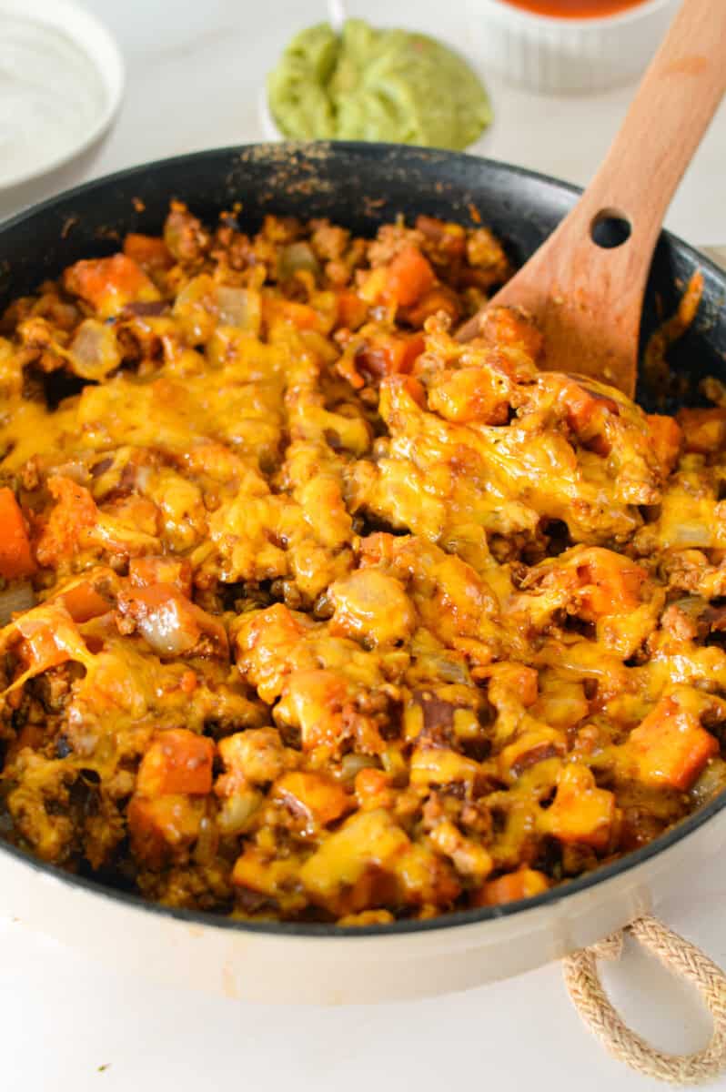 Birds eye of a turkey sweet potato skillet topped with melting cheese.
