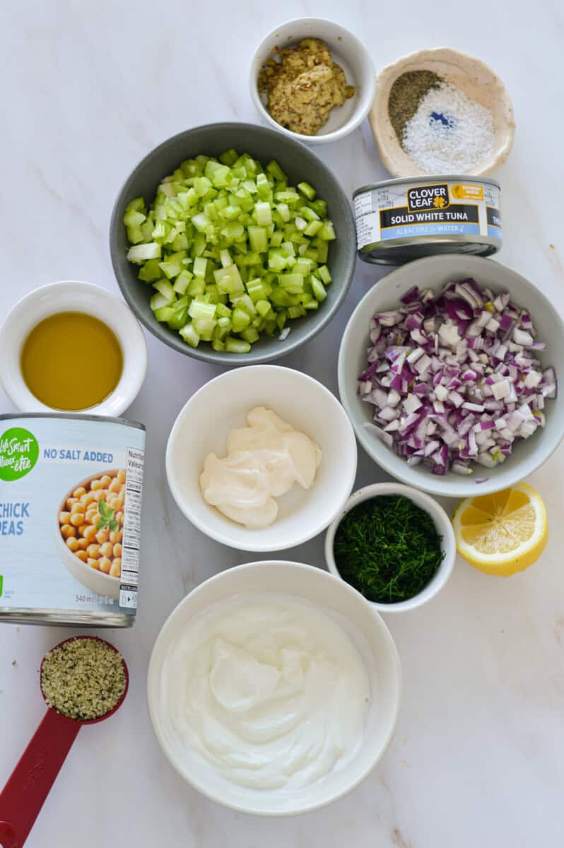 Inredients including celery, red onion, mayo, greek yogurt, chickpeas, tuna, dill, olive oil and spices.