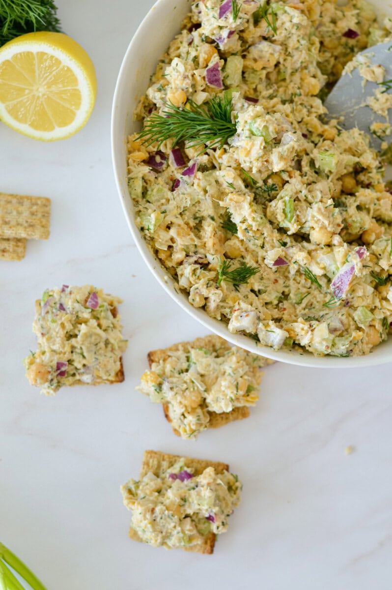 Serving chickpea tuna salad on crackers.