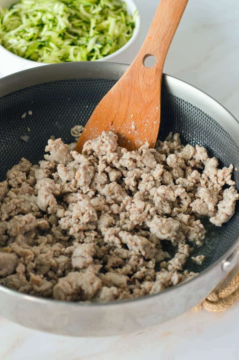 Cooking up ground sausage in a pan.