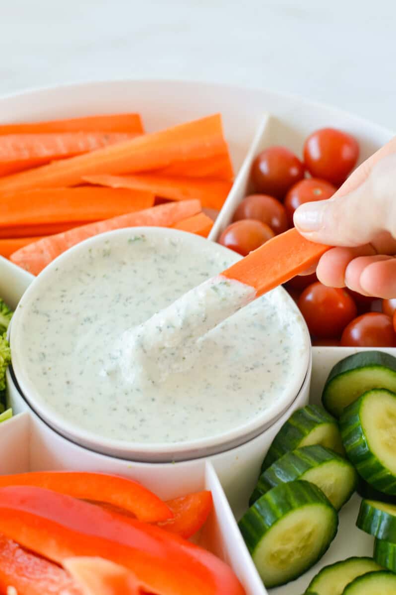 Dipping a carrot in cottage cheese ranch dip.