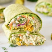 Two halves of a crunchy chicken wrap stacked.