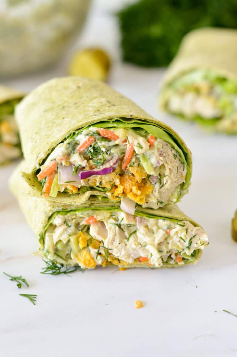 Two halves of a crunchy chicken wrap stacked.