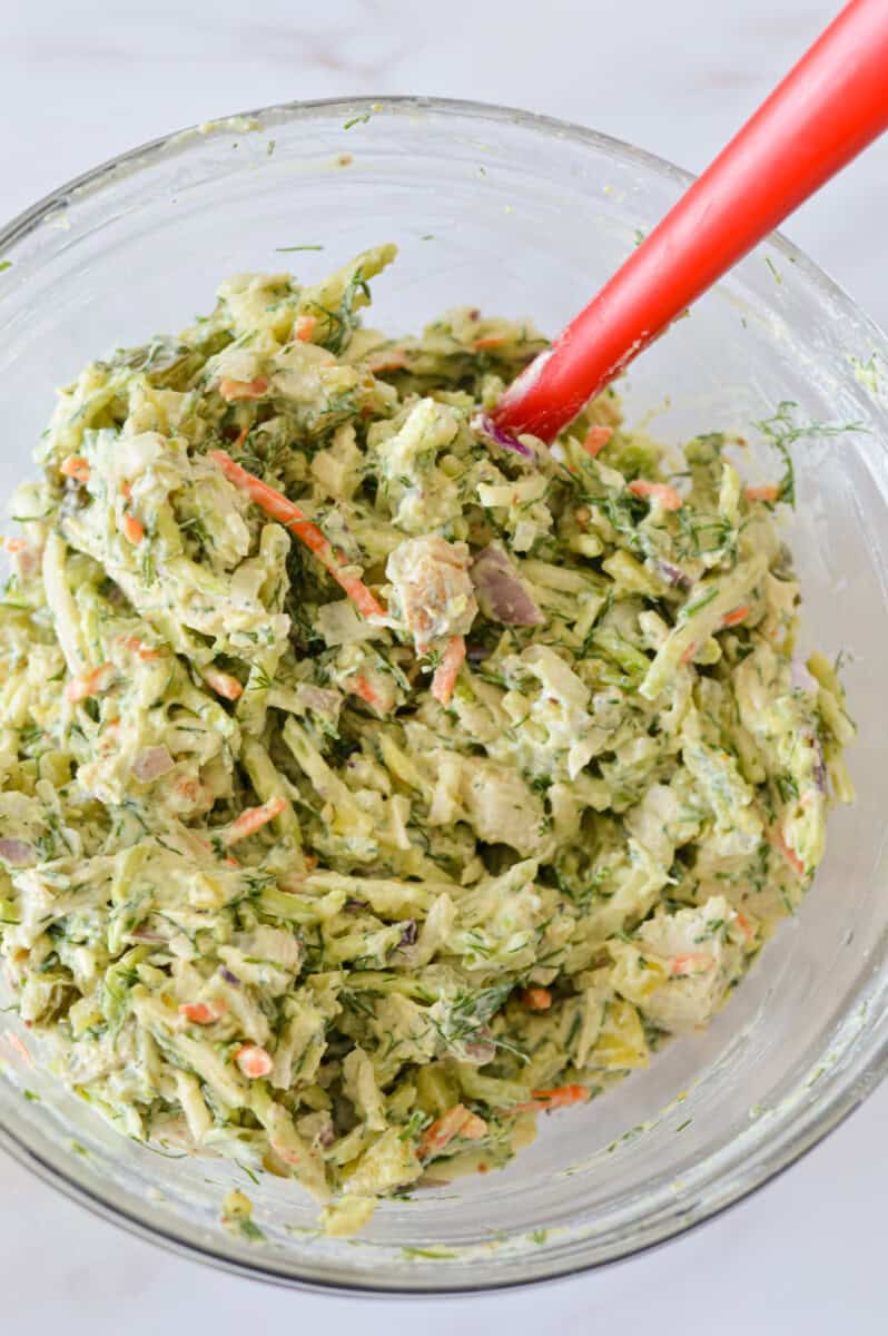 Mixing a bowl of dill pickle chicken salad.