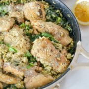 Pan of pesto chicken thighs and rice.