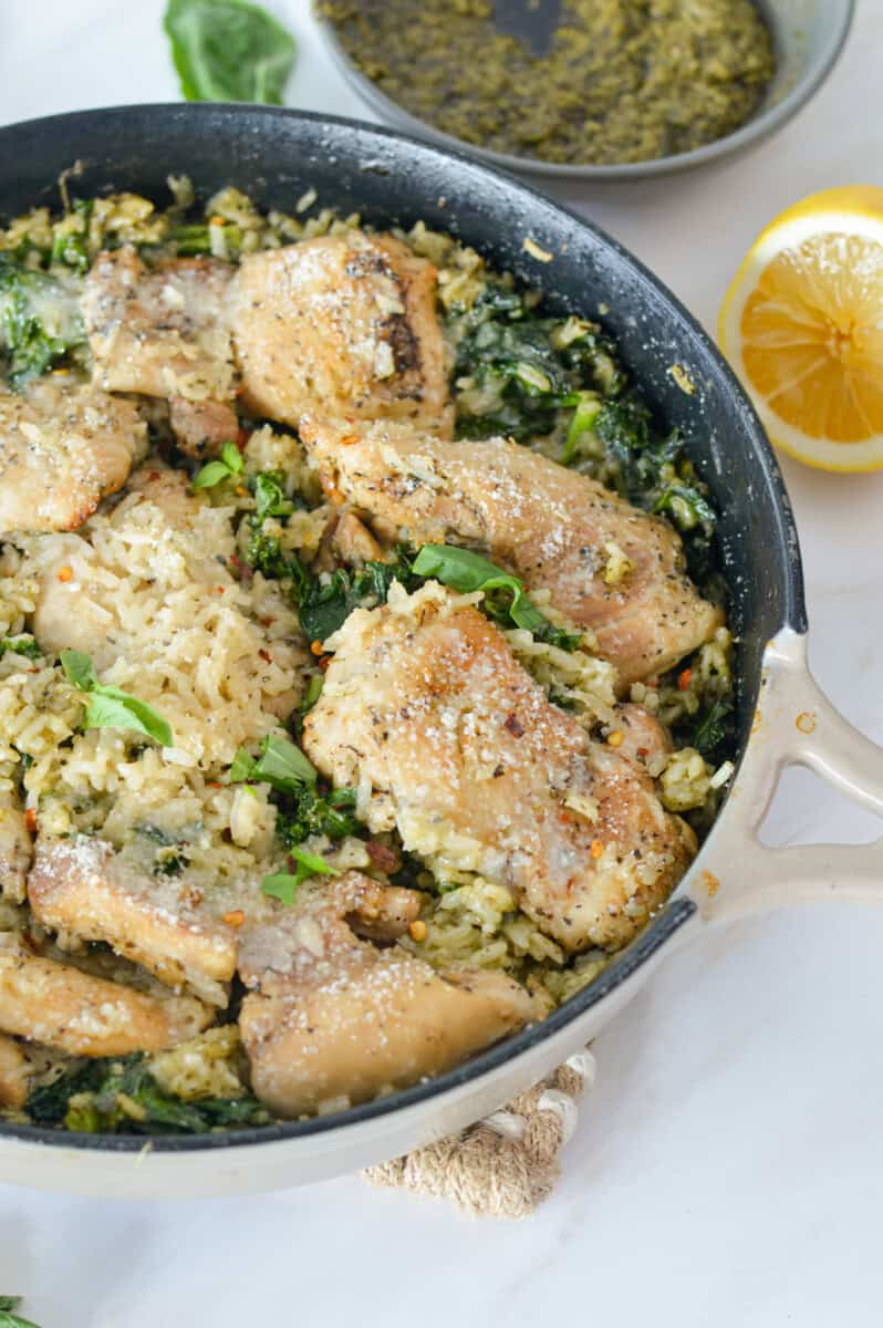 Pan of pesto chicken thighs and rice.