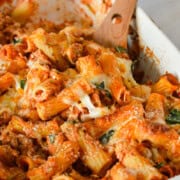 Scooping sausage pasta bake.
