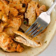 Birds eye with plate of air fryer chicken thighs.