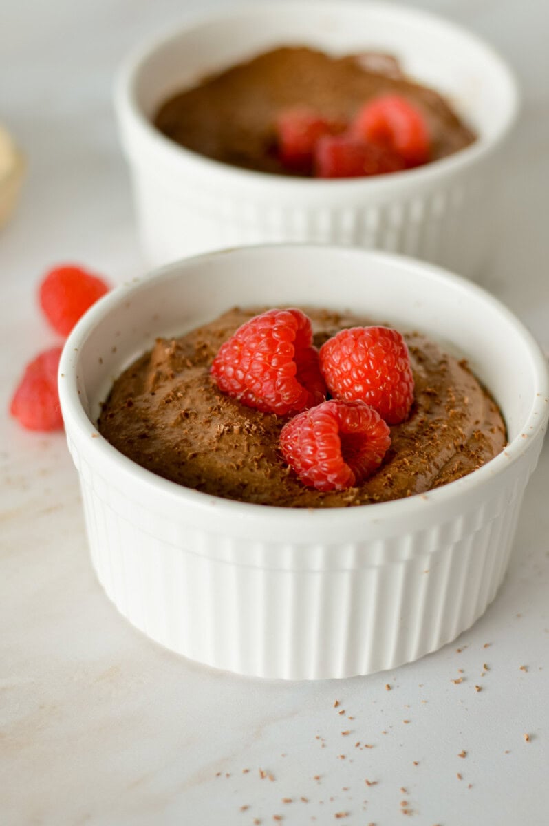 Close up of a cottage cheese chocolate mousse with raspberries.