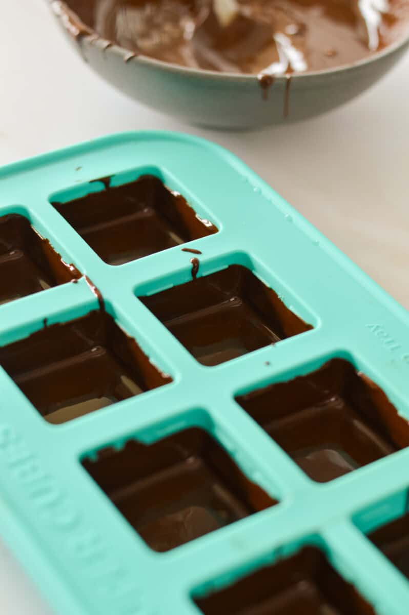 An icecube tray coated with melted chocolate