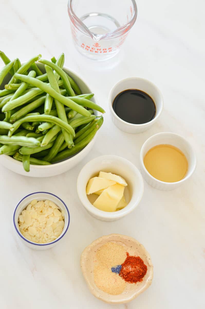 Ingredients including green beans, soy sauce, butter, honey, sauce and spices.