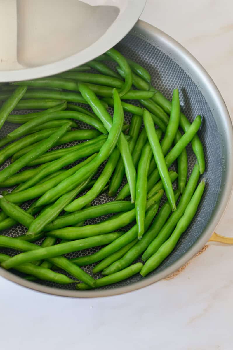 Steaming a pan of green beans.