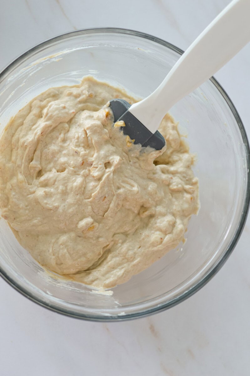 Mixing a bowl of mashed banana and greek yogurt.