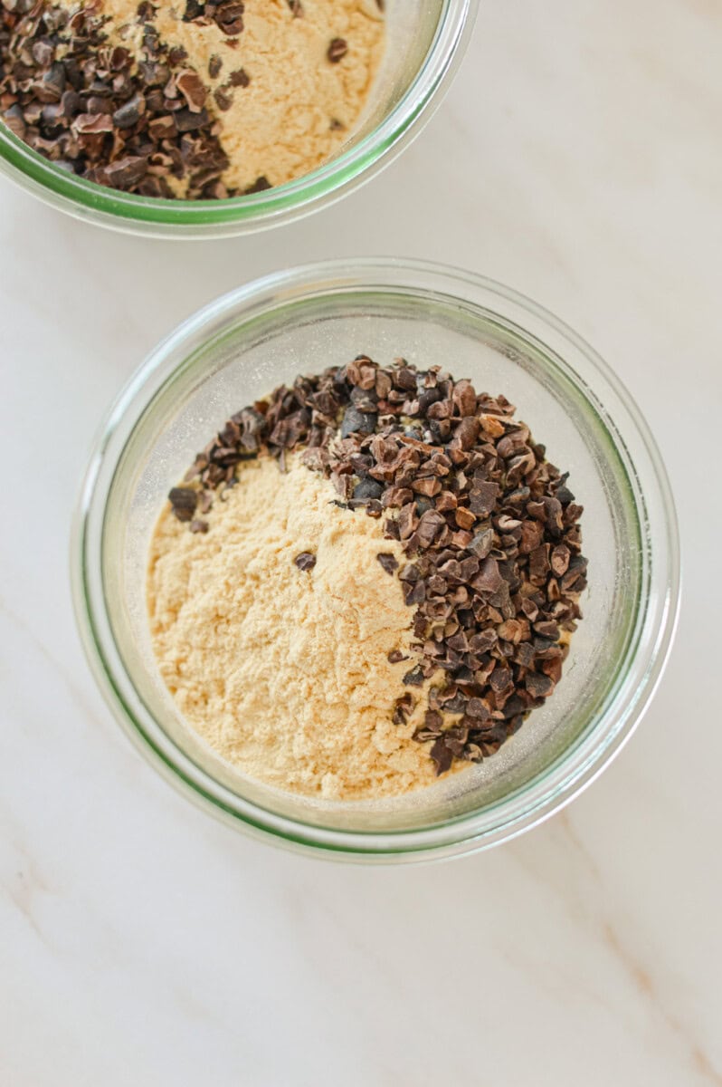 Birds eye with jar of oats, chia seeds, vanilla protein and cacao nibs.
