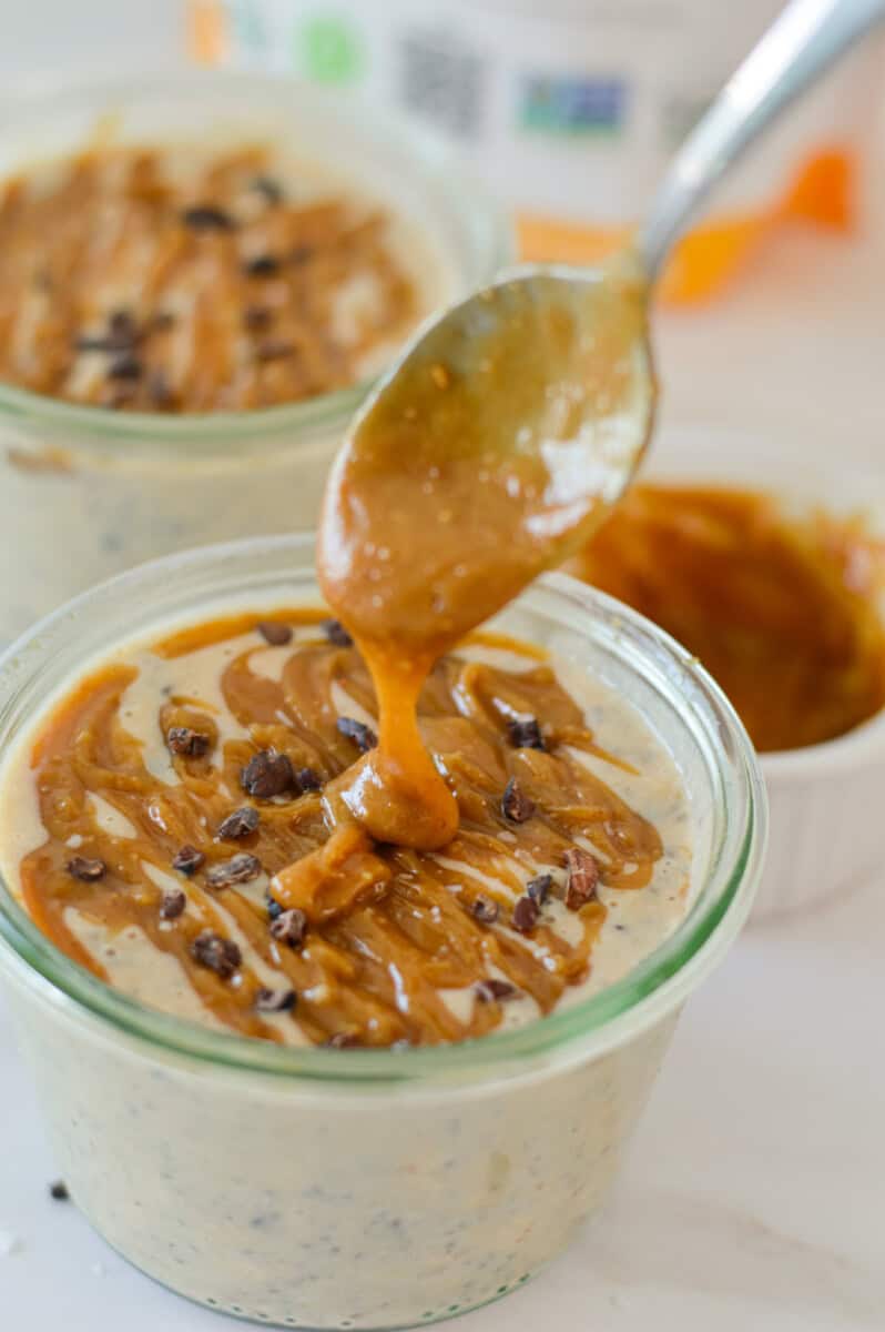 Drizzling homemade caramel on salted caramel overnight oats.