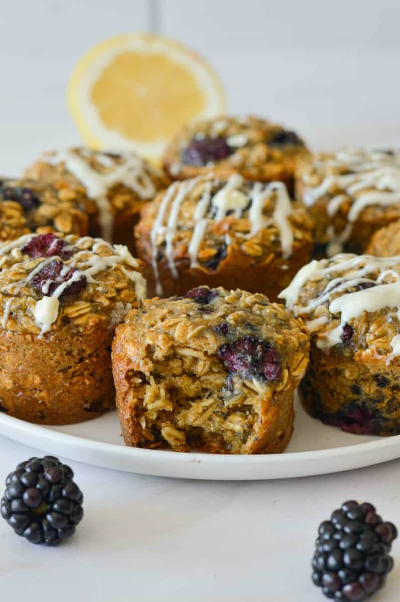 Plate of lemon and blackberry oatmeal cups with icing drizzle.