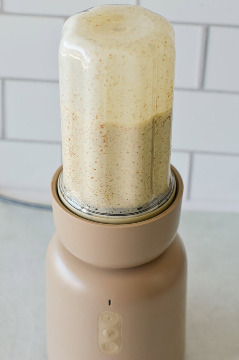 Blending cottage cheese, eggs and flaxseed in a blender.