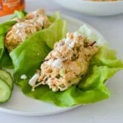 Plate with buffalo chicken salad in lettuce wraps.