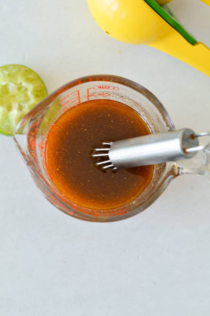 Whisking together a dressing for couscous salad.