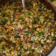Birds eye of a bowl with elotes pasta salad.