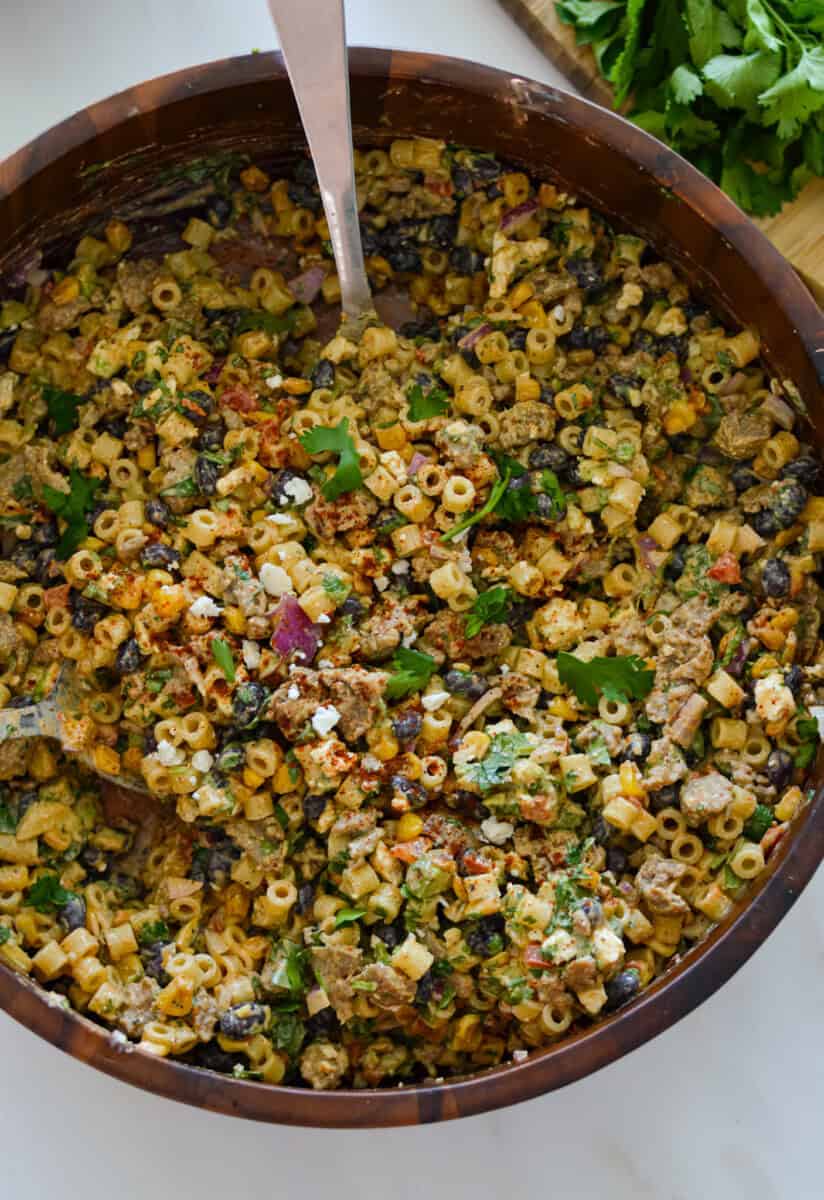 Birds eye of a bowl with elotes pasta salad.
