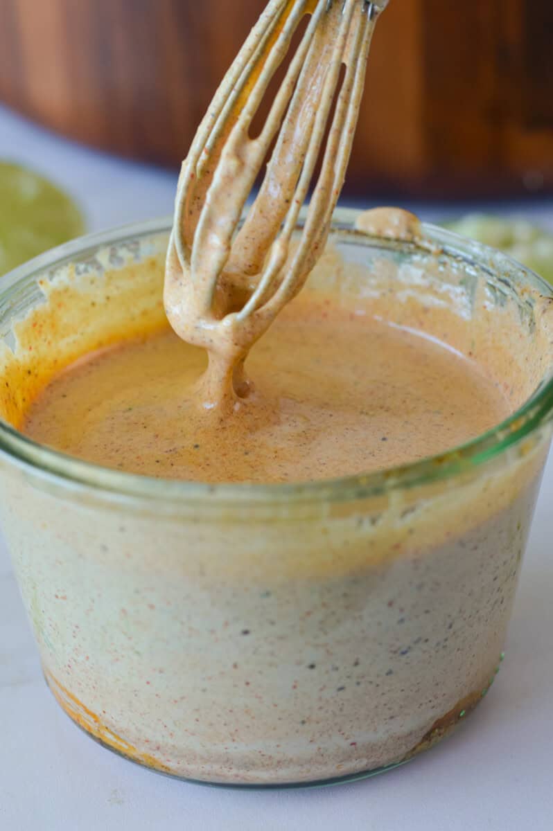 Mixing together salad dressing for elotes pasta salad.