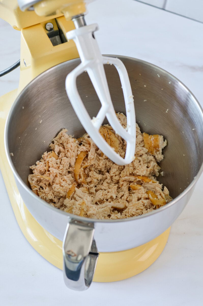 Shredding chicken breasts in a stand mixer.