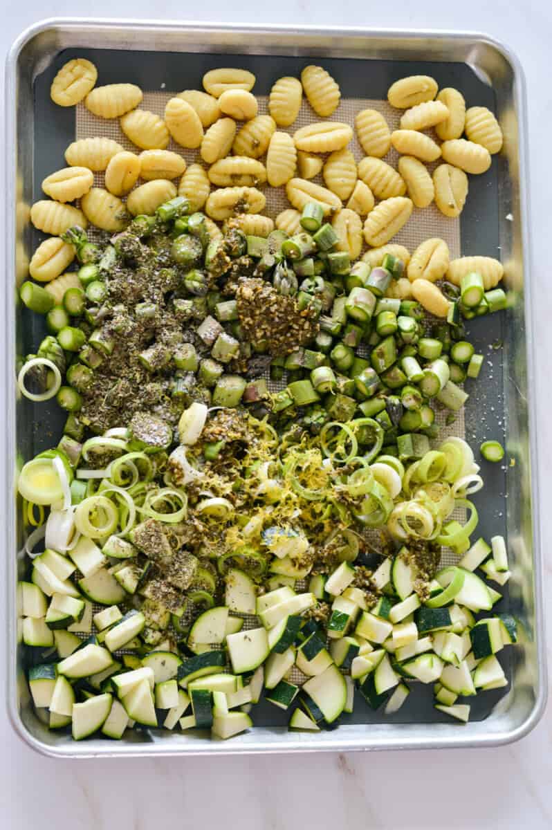 Unmixed sheet pan with gnocchi, green onion, leek, asparagus and zucchini.