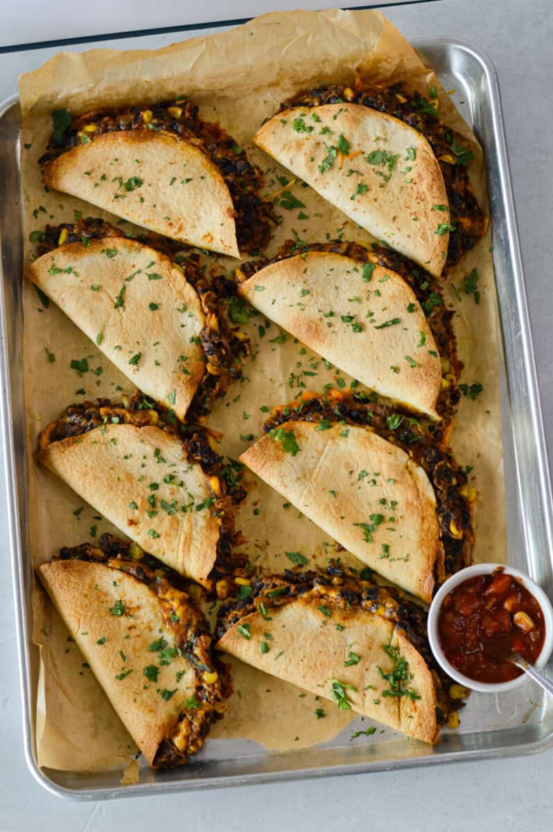 Birds eye of baked black bean tacos on a tray.