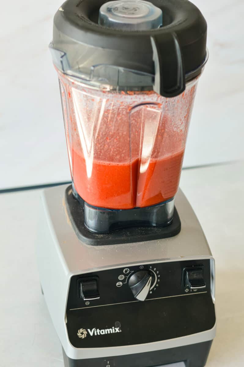 Blending strawberries in a blender.